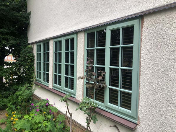 Outside view of house windows and a wooden balcony showing the ways of preventing condensation in winter