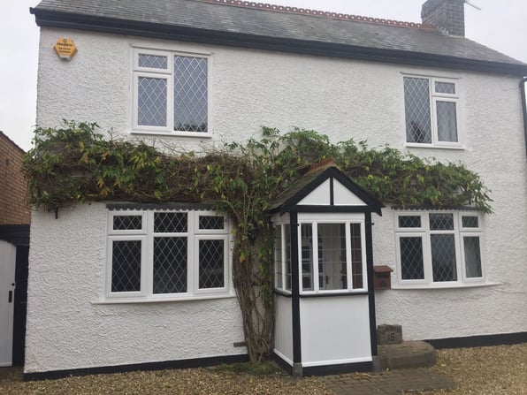 After investing in some new energy efficient windows a homeowner feels all the benefits of having made such an investment.