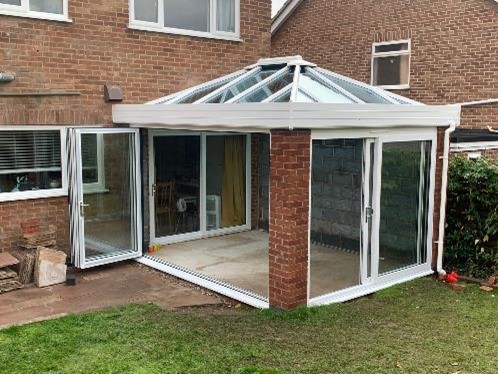 Empty conservatory being built with glass windows and glass roof to show all you need to know about building regulations part L