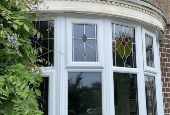 A home where the picture of the front covered in trees is represented by these window frames.