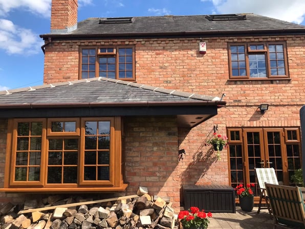 Outside view of house with glass windows and doors to show what can cause exterior window condensation.