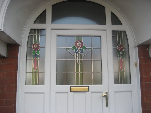 A close up image of a stained glass energy efficient front door that was installed by Harveys Windows.