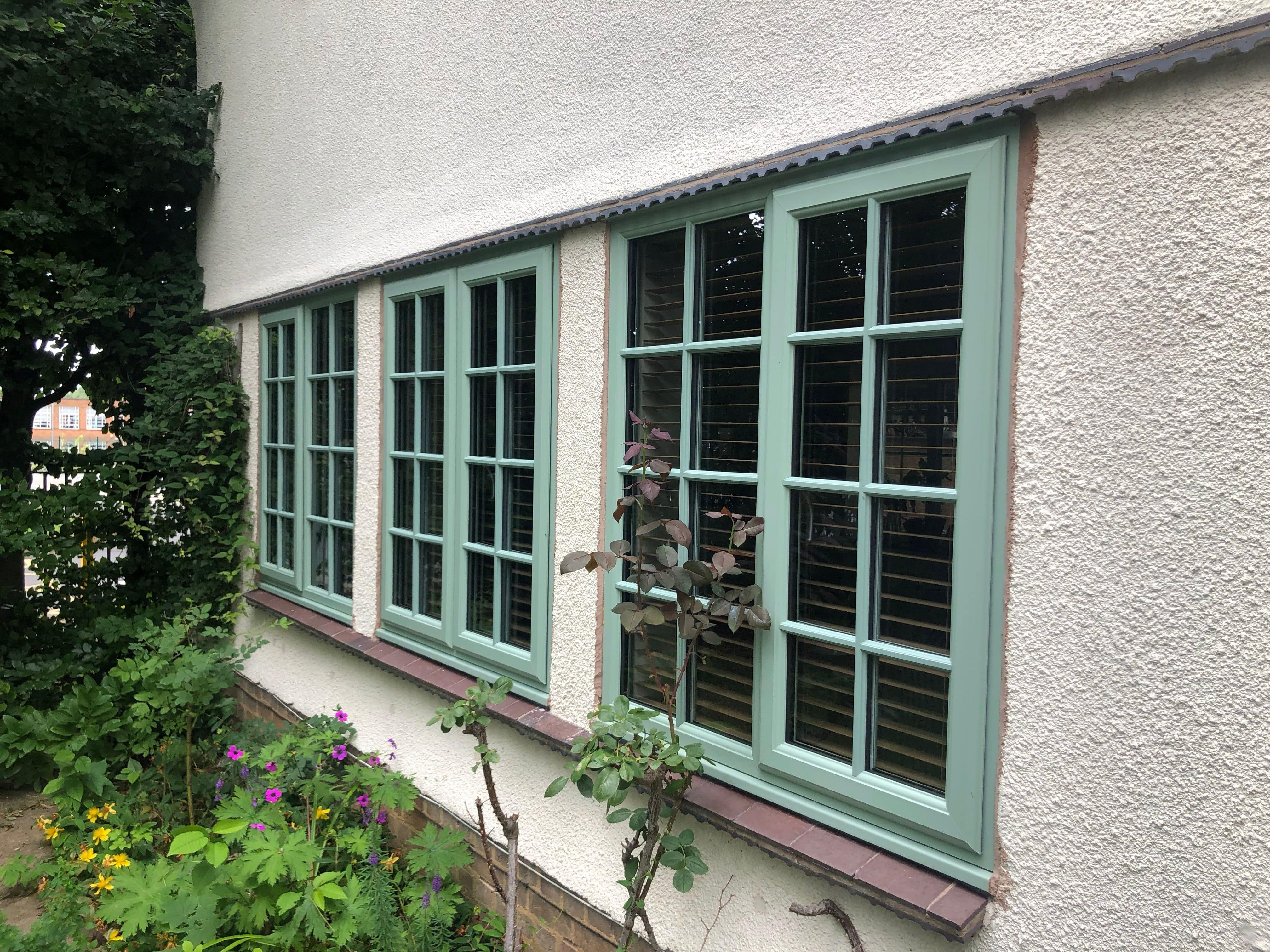 Outside view of house windows and a wooden balcony showing the ways of preventing condensation in winter 