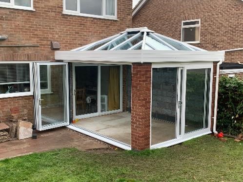 Empty conservatory being built with glass windows and glass roof to show all you need to know about building regulations part L 